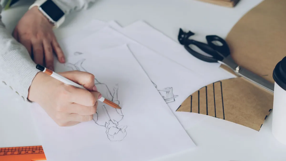 Designer sketching a new logo concept and brand marks by hand