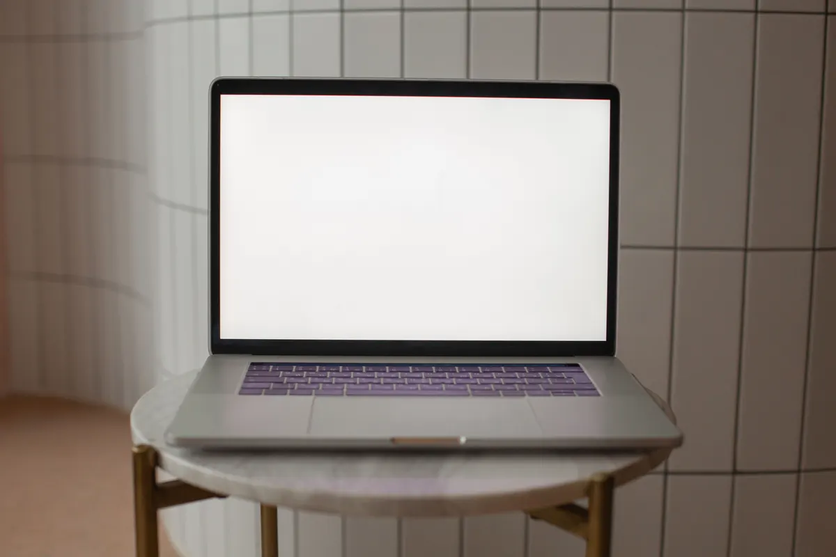 A laptop on a small table ready for a website review session