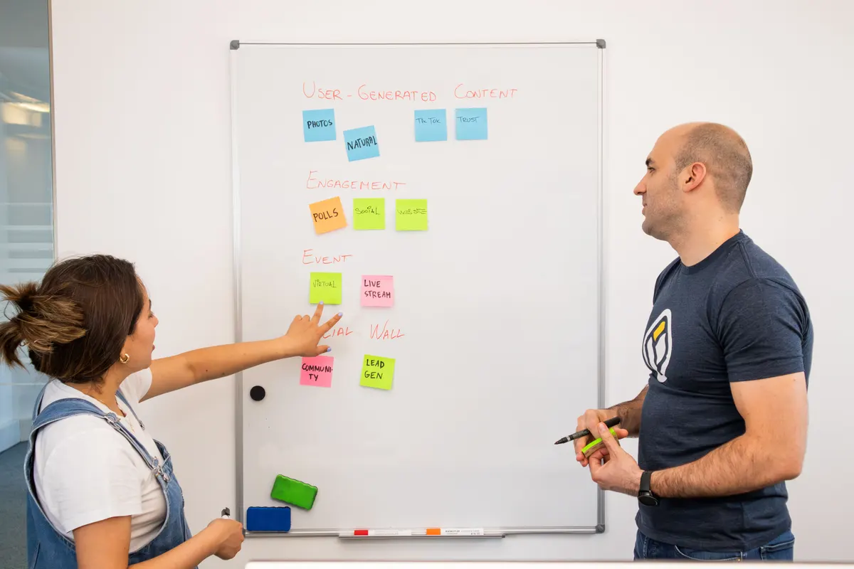 Two strategists mapping out a reputation and trust plan on a whiteboard